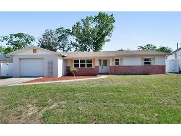 Charming single-story home with a well-maintained front yard and an attached single-car garage at 920 Trafalgar St, Deltona, FL 32725