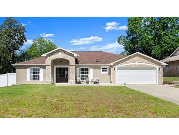 Charming single-story home with stone accents, inviting front porch, and well-manicured lawn at 2600 Scottville Ave, Deltona, FL 32725