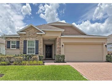 Beautiful single Gathering home with a stone facade, two car garage, and well-manicured lawn at 110 No Name Key Dr, Deland, FL 32720