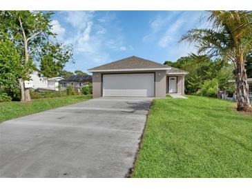 Charming single-story home featuring an attached two-car garage and a well-manicured lawn at 1226 North St, Daytona Beach, FL 32114