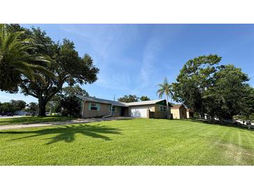 Charming single-story home with well-maintained lawn, mature trees, and a two-car garage at 1301 Killian St, Daytona Beach, FL 32114