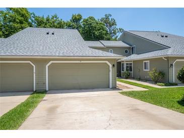 Attractive condo featuring a two-car garage, well-kept lawn, and mature trees in a great location at 15 Misners Trl, Ormond Beach, FL 32174