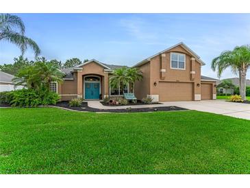 Charming single-Gathering home with a well-manicured lawn and a beautiful blue front door at 1910 Creekwater Blvd, Port Orange, FL 32128