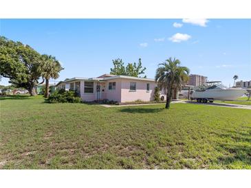Charming single-story home with a well-maintained lawn and boat on a trailer in the driveway at 3267 S Peninsula Dr, Daytona Beach, FL 32118