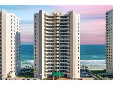 Exterior view of the condominium building showcasing ocean views and a well-maintained facade at 3315 S Atlantic Ave # 1406, Daytona Beach Shores, FL 32118