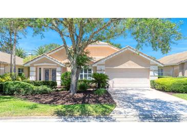 Charming single-story home featuring a neutral color palette, a two-car garage and mature landscaping at 438 Harbour Town Ln, Ormond Beach, FL 32174