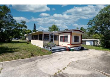 Charming single-story home featuring a well-maintained lawn, concrete driveway, and inviting entryway at 487 Collins St, Ormond Beach, FL 32174