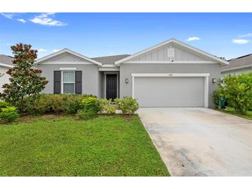 Charming single-story home with a well-manicured lawn and inviting entrance and two car garage at 1002 River Falls Cir, Deland, FL 32720