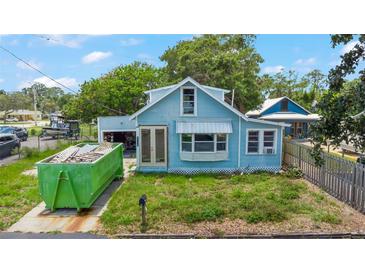 Charming blue bungalow with a tidy yard, perfect for a cozy, relaxed living at 104 N Park Pl, Edgewater, FL 32132