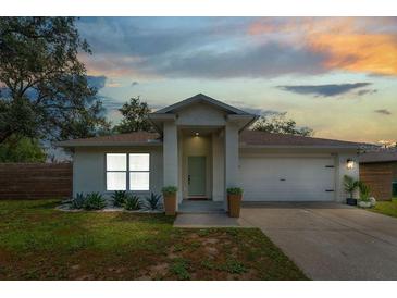 Charming single-story home featuring a two-car garage, well-manicured lawn and pleasing landscaping at 1092 Gage Ave, Deltona, FL 32738