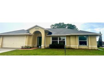 Charming single-story home featuring a lush green lawn and an attached two-car garage at 1101 Anderson St, Deltona, FL 32725