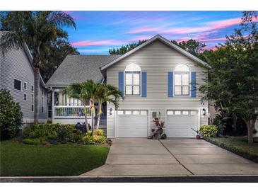 Charming two-story home featuring a two-car garage and lush landscaping with palm trees at 275 Bayou Cir, Debary, FL 32713