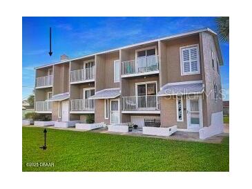 A well-maintained building with multiple units, featuring balconies and green space at 2898 Ocean Shore Blvd # 603, Ormond Beach, FL 32176