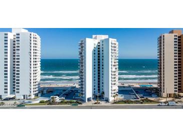 Oceanfront condo building featuring white balconies, direct beach access, and convenient parking at 3047 S Atlantic Ave # 1805, Daytona Beach, FL 32118