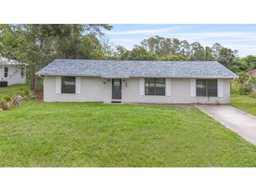 Charming single-story home featuring a well-maintained lawn and a classic facade at 2127 3Rd Ave, Deland, FL 32724