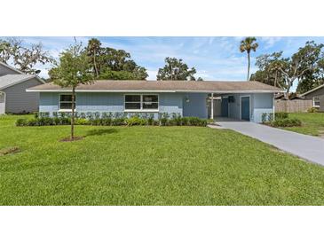 Charming single story home with a well-manicured lawn and appealing landscaping at 2720 Kumquat Dr, Edgewater, FL 32141