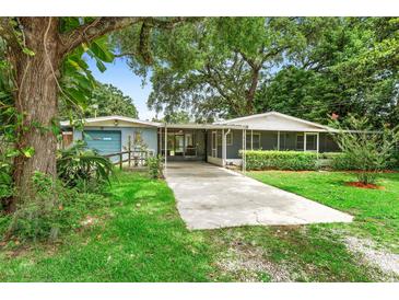 Charming single-story home with lush landscaping and a welcoming driveway at 507 Sand Ave, Apopka, FL 32703