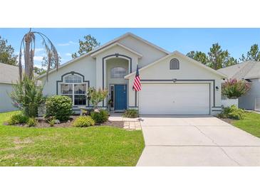 Charming single-Gathering home with a well-manicured lawn and an American flag at 824 Casterton Cir, Davenport, FL 33897