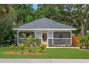 Charming home featuring a welcoming front porch, nicely landscaped lawn, and beautiful curb appeal at 832 Donnelly Pl, Daytona Beach, FL 32114