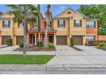 Charming townhome showcasing well-maintained landscaping, attached garages, and welcoming front entrances at 893 Assembly Ct, Reunion, FL 34747