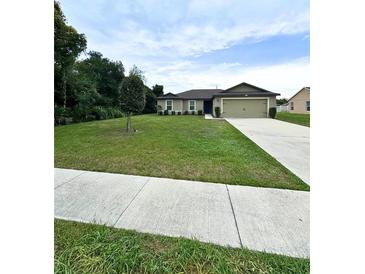 Charming single-story home boasts a well-manicured lawn, neutral exterior, and an attached two-car garage at 1115 Adirondack St, Deltona, FL 32725