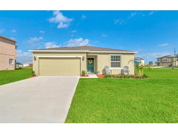 Charming single-story home featuring a well-maintained lawn, neutral exterior, and a two-car garage at 136 Columbia Dr, Kissimmee, FL 34759
