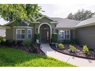 Charming home featuring a meticulously landscaped front yard and inviting front entrance at 19232 Park Place Blvd, Eustis, FL 32736