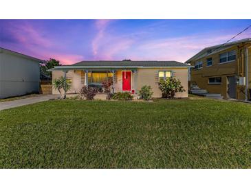 Charming home with a well-manicured lawn and a vibrant red front door at 505 Wisteria Rd, Daytona Beach, FL 32118