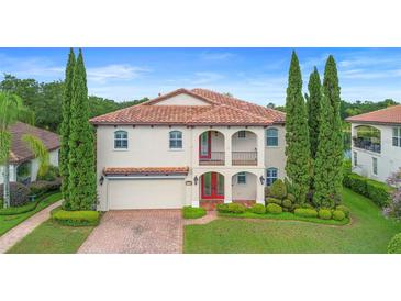 Two-story home with a tile roof, arched entry, and manicured landscaping at 762 Onyx Pkwy, Deland, FL 32724