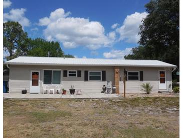 Charming single-story home featuring a durable metal roof and neutral-colored siding, perfect for low-maintenance living at 942 Lemon Bluff Rd, Osteen, FL 32764