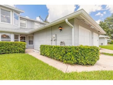 Charming home exterior with well-manicured lawn and attached two-car garage at 961 S Lakewood Ter # C, Port Orange, FL 32127
