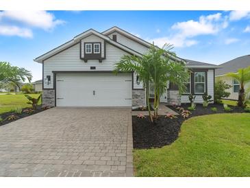 Charming one-story home featuring a two-car garage, well-maintained landscaping, and a welcoming facade at 141 Mosaic Blvd, Daytona Beach, FL 32124