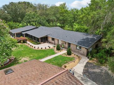 Aerial view of the home highlighting the well-kept yard and architectural design at 1555 Mercers Fernery Rd, Deland, FL 32720