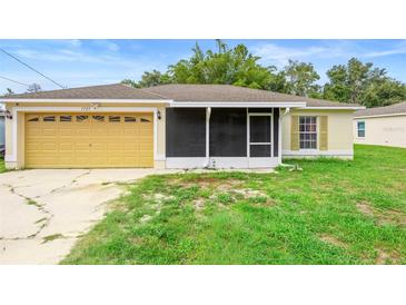 Charming single-story home with a large garage and screened porch in a quiet neighborhood with blue skies overhead at 1725 12Th St, Orange City, FL 32763