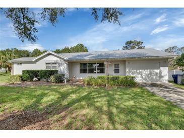 Charming single-story home featuring a well-maintained lawn and an attached two-car garage at 2676 Palm Terrace St, Deland, FL 32720