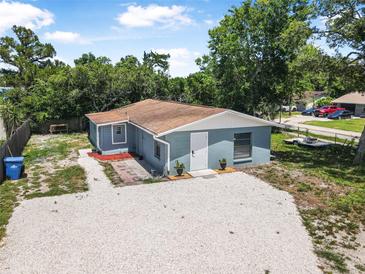 Charming home with a gravel driveway and lush greenery, creating a welcoming and serene ambiance at 1214 Flomich St, Daytona Beach, FL 32117