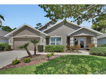 Charming home exterior showcasing manicured landscaping and a welcoming front entrance at 1329 Sunningdale Ln, Ormond Beach, FL 32174