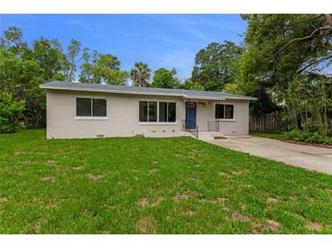 Charming single story home featuring a bright green lawn, refreshed exterior paint, and inviting blue door at 182 Grove St, Ormond Beach, FL 32174