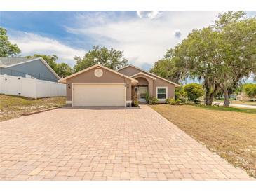 Charming single-story home with a brick driveway and well-maintained lawn and mature trees at 198 Heather Lane Dr, Deltona, FL 32738