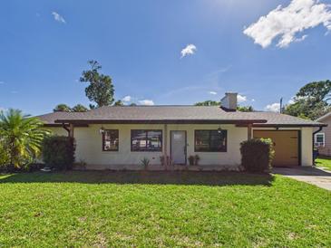 Charming single-story home featuring a well-maintained lawn and neutral color palette at 2526 Victory Palm Dr, Edgewater, FL 32141