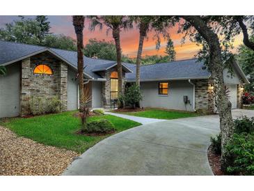 Charming single-story home with brick accents, mature trees and a beautiful lawn at 4791 S Peninsula Dr, Ponce Inlet, FL 32127