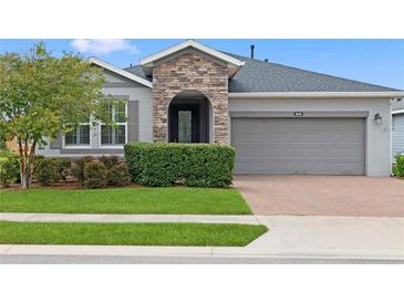 Charming single-Gathering home featuring a stone accent entrance and well-maintained landscaping at 5648 Nw 40Th Loop, Ocala, FL 34482