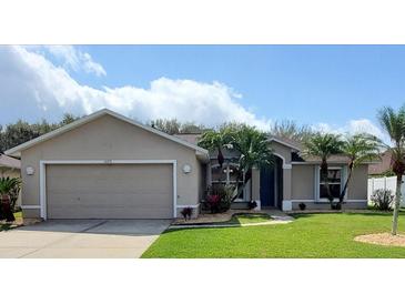 Charming single-story home with a well-manicured lawn and a two-car garage at 1693 Arash Cir, Port Orange, FL 32128