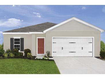 One-story home with two-car garage, landscaping, and neutral color palette at 310 Biltmore Blvd, Dundee, FL 33838