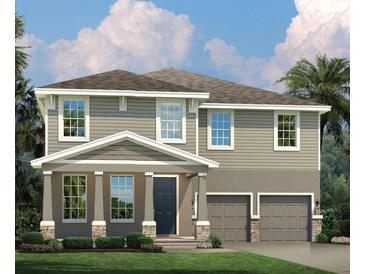 Two-story home with gray siding, stone accents, and a two-car garage at 3785 Voyageurs Ct, Apopka, FL 32712