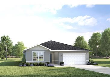 One-story home with gray siding, two-car garage, and landscaped lawn at 1913 Quail Fields Cir, Winter Haven, FL 33884