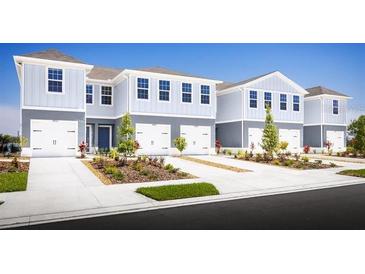 Two-story townhouses with attached garages and landscaping at 2302 Incandescent Way, South Daytona, FL 32119