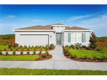 Charming one-story home with a two car garage, a well maintained yard, and a neatly layed walkway at 1624 Covey Rise Ter, Winter Haven, FL 33884