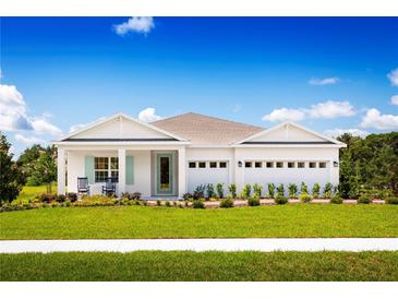 Charming single-story home with a manicured lawn and a bright, inviting facade under a sunny blue sky at 1632 Covey Rise Ter, Winter Haven, FL 33884