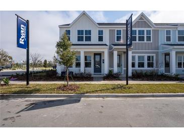 Beautifully designed townhome with a manicured lawn, welcoming curb appeal, and a Ryan Homes branded banner at 631 Highfalls Ave, Debary, FL 32713